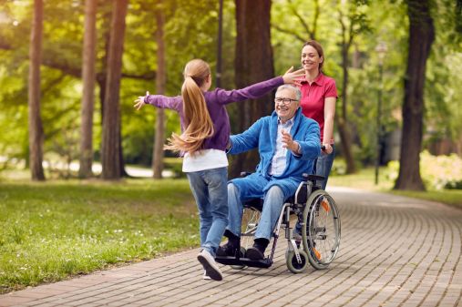 A family and support worker enjoying time together at a park