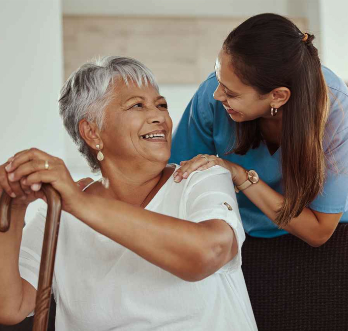 A support worker helping a client with daily routines at home